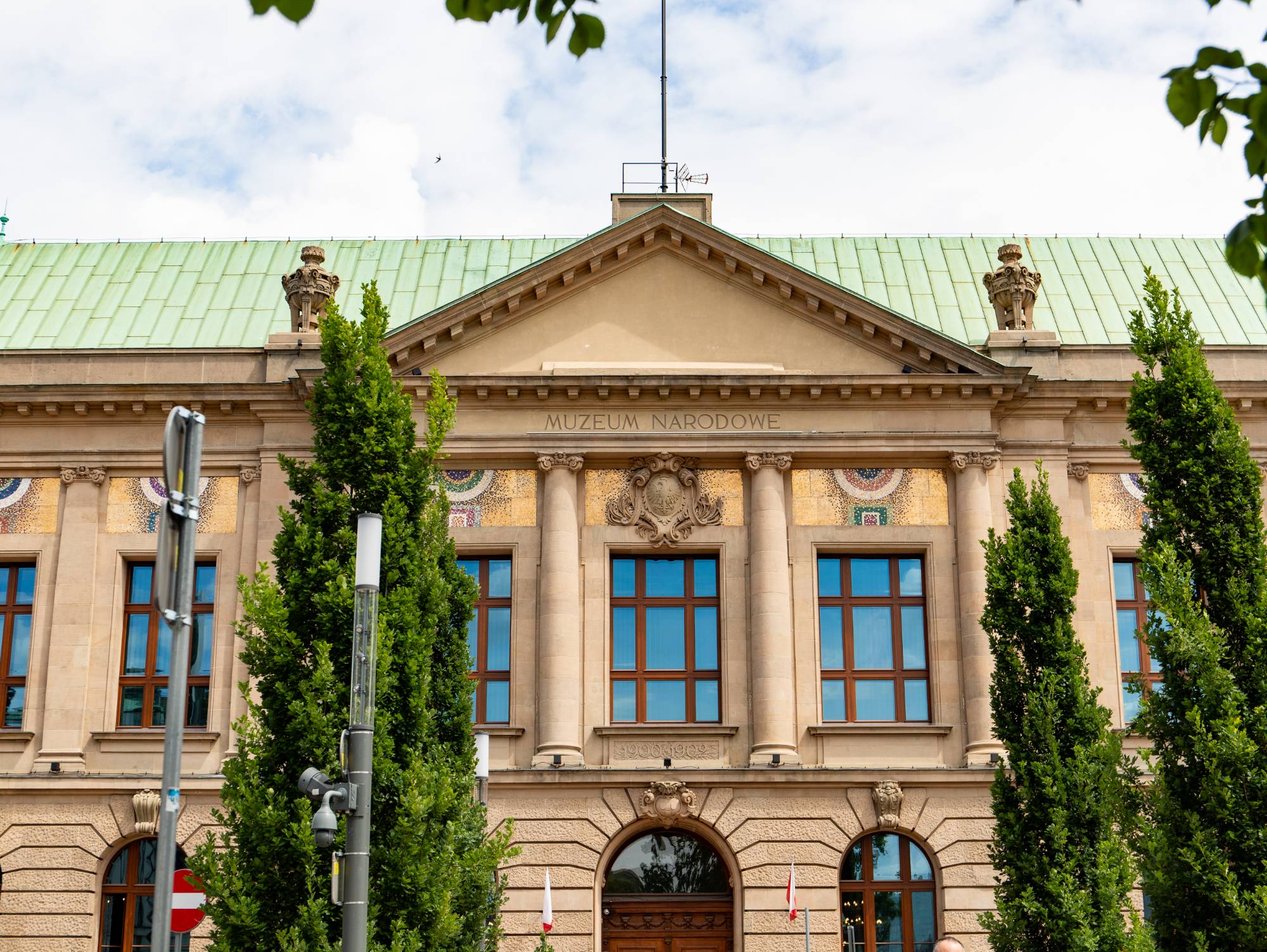 The façade of the National Museum building in Poznań, with its pediment, inscription and mosaics above the windows