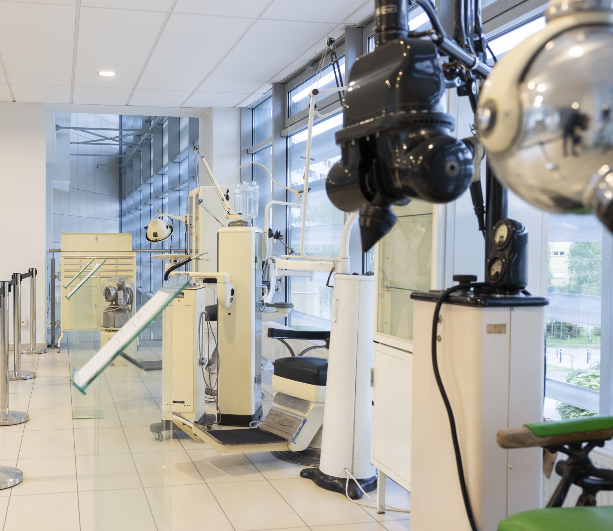 Historic medical equipment in the Poznań University of Medical Sciences Museum, with a dental chair and an X-ray lamp